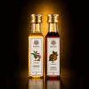 Two bottles of Kaizer oil with labels on a gradient background