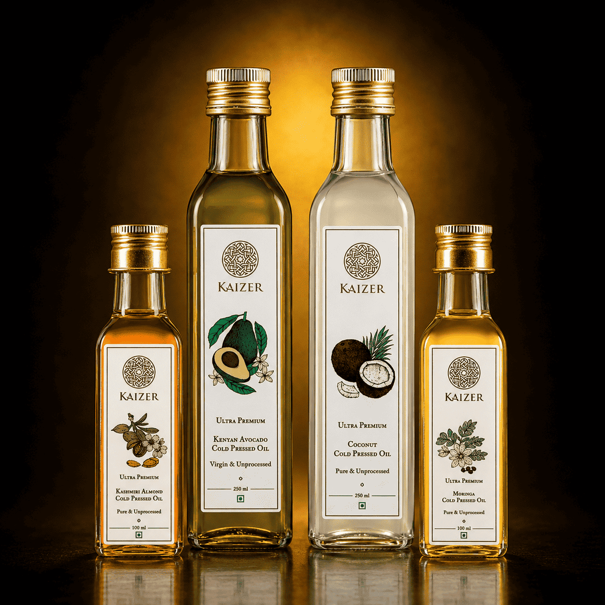 Four Kaizer branded glass bottles of cold pressed oils arranged on a reflective dark surface against a black background with warm golden light.