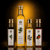 photography shot of four Kaizer cold-pressed oil bottles grouped together as a bundle: Malkangani Cold Pressed Oil (100 ml), White Sesame Cold Pressed Oil (250 ml), Moringa Cold Pressed Oil (100 ml), and Pumpkin Seed Cold Pressed Oil (100 ml)