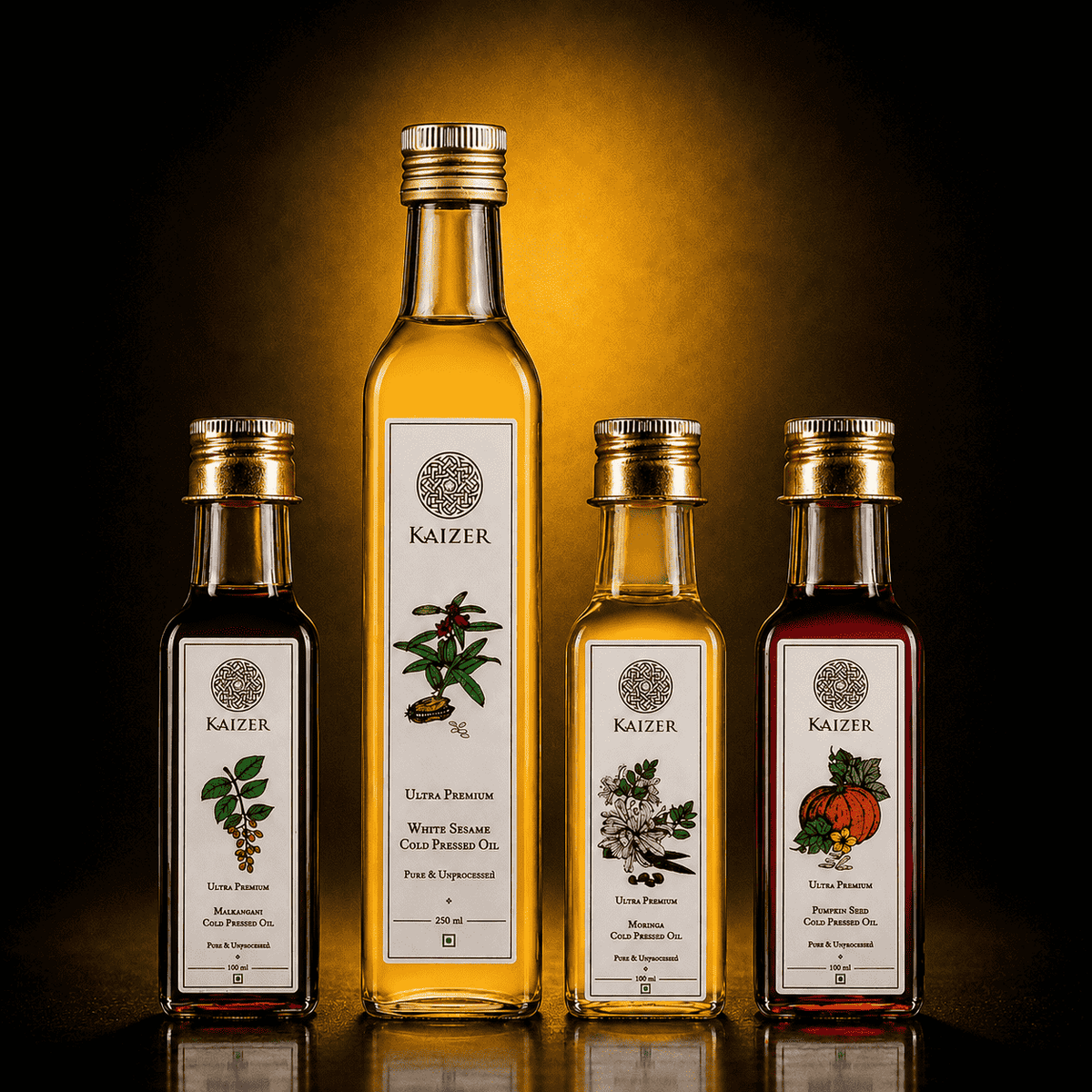 photography shot of four Kaizer cold-pressed oil bottles grouped together as a bundle: Malkangani Cold Pressed Oil (100 ml), White Sesame Cold Pressed Oil (250 ml), Moringa Cold Pressed Oil (100 ml), and Pumpkin Seed Cold Pressed Oil (100 ml)