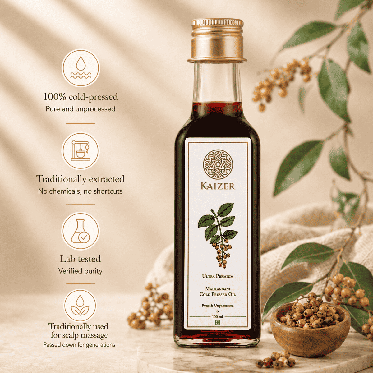 A bottle of Kaizer Malkangani Oil stands on a wooden surface with decorative leaves, berries, and a small bowl of seeds. Text on the left highlights key product benefits: 100% cold-pressed, traditionally extracted, lab tested, and traditionally used for scalp massage.